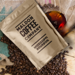 Brown bag of Mississippi Bourbon coffee beans.