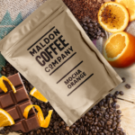 Brown bag of mocha orange coffee beans.