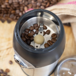 Coffee beans inside of the Quest compact coffee grinder.