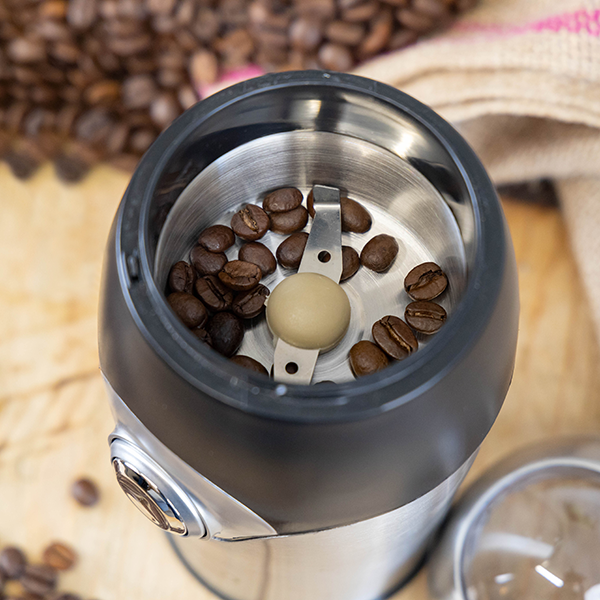 Coffee beans inside of the Quest compact coffee grinder.