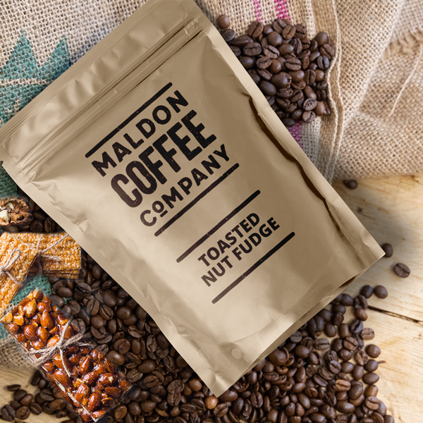 Toasted nut fudge coffee beans in a brown sealed bag.